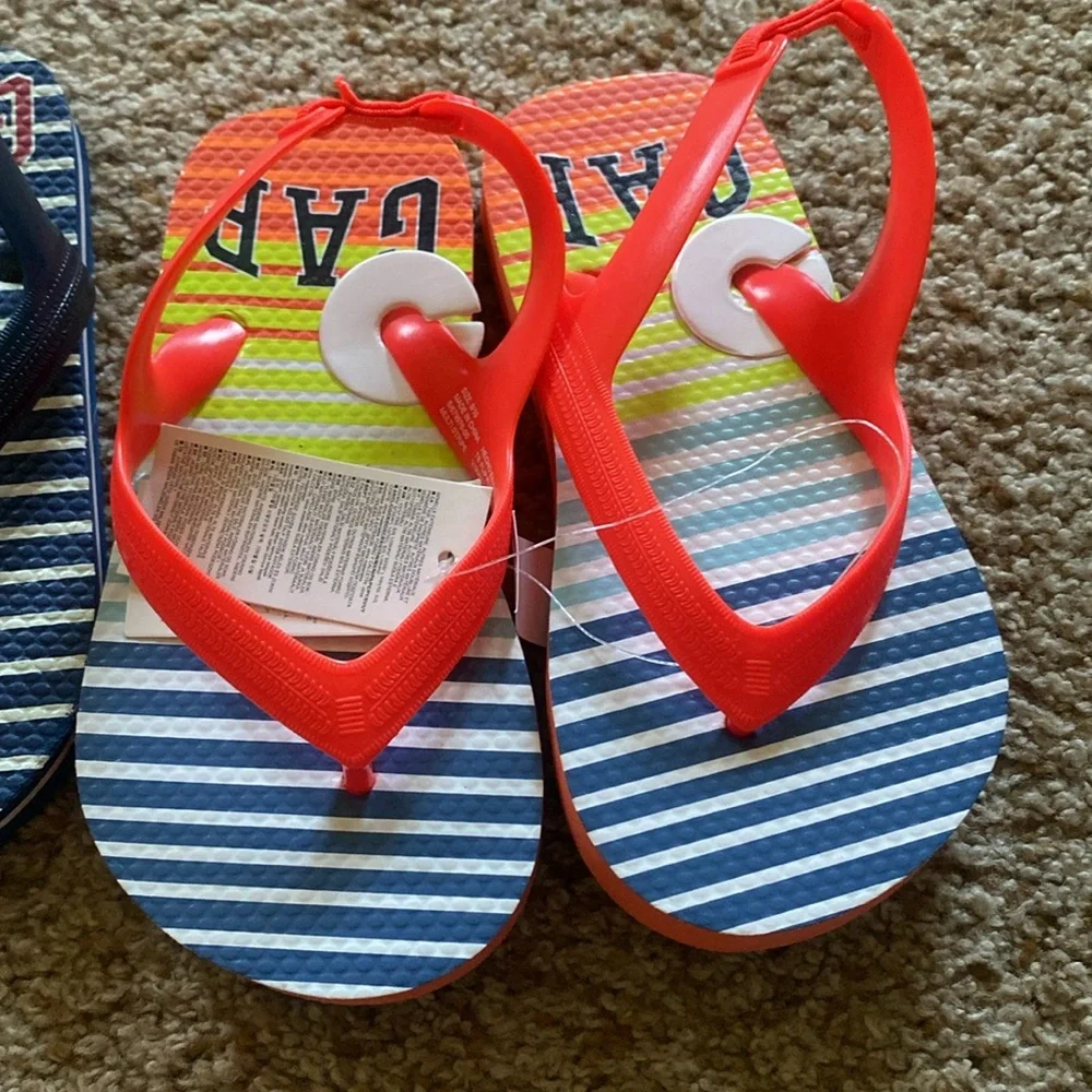 2 pairs Gap flip flops sz 10. NWOT blue/white striped. NWT neon orange striped.